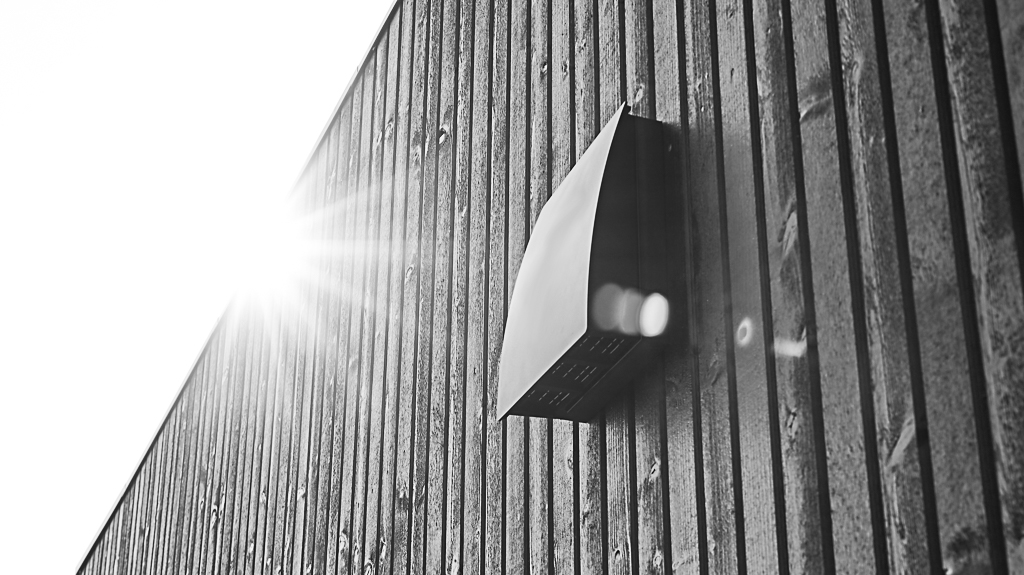 DUKA One DO 30 storm shield in black on spacer placed on a black wooden wall