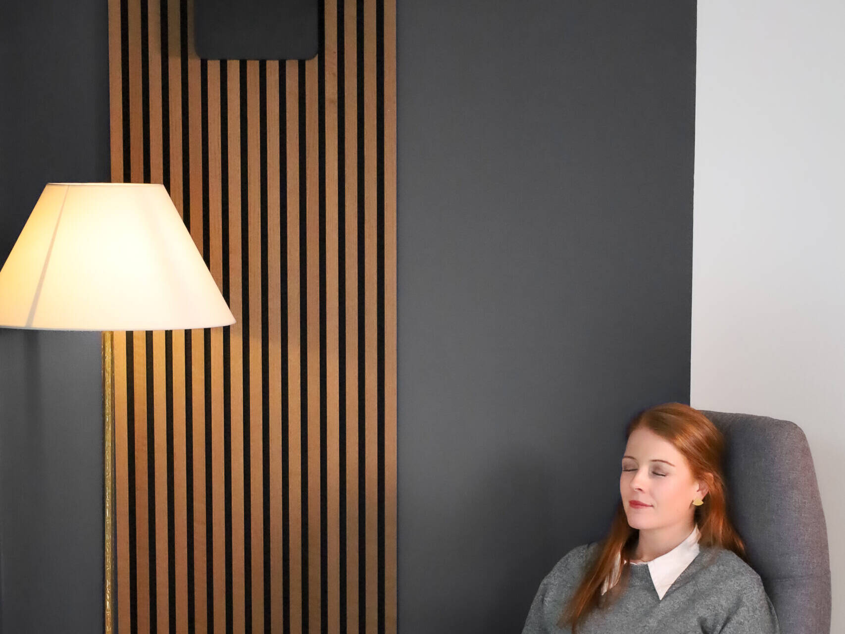 woman in front of black duka one pro 50 s in a reading corner