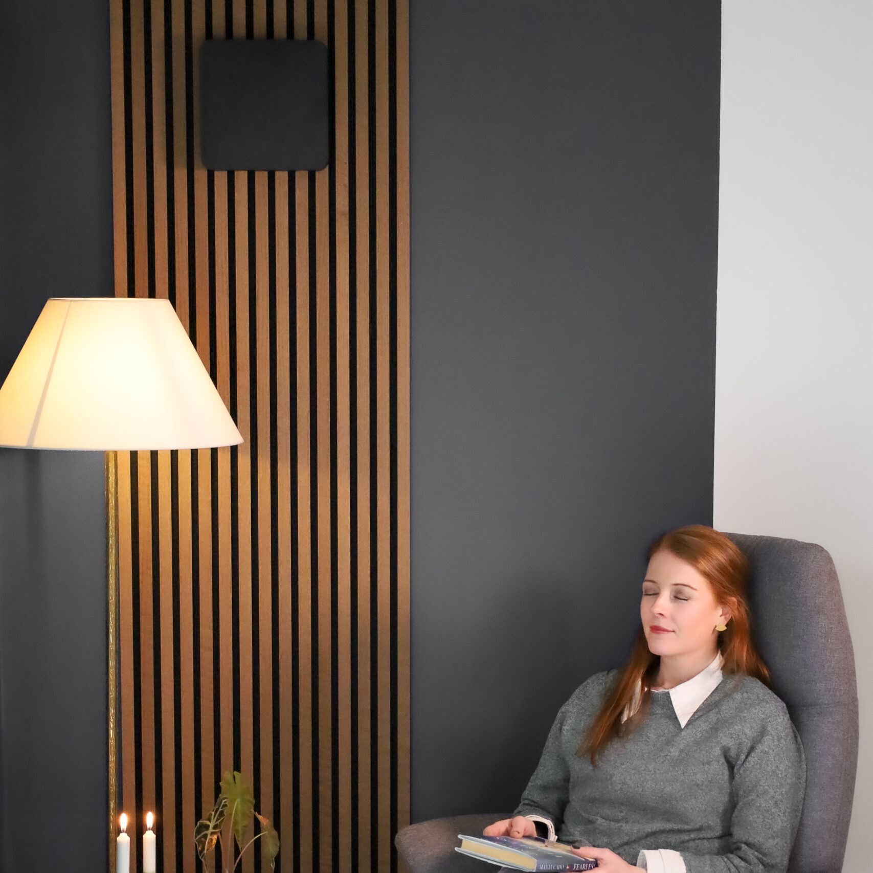 woman in front of black duka one pro 50 s in a reading corner